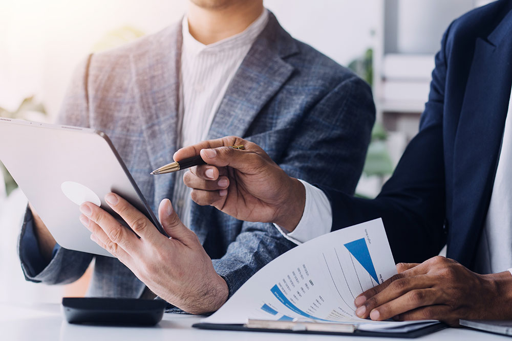 Financial analysts analyze business financial reports on a digit